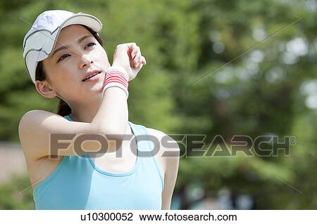 Young Woman Wiping Sweat View Large Photo Image Stock Image - Young Woman Wiping Sweat. Fotosearch