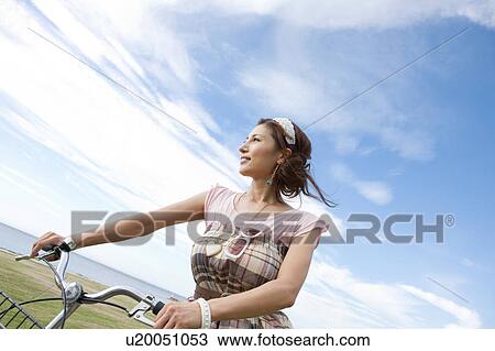 Stock Image - Young Woman with Bicycle. Fotosearch