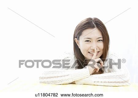 Young woman with finger on lips, Tokyo Prefecture, Honshu, Japan View Large Photo Image Stock Image - Young woman with finger on lips, Tokyo Prefecture, Honshu, Japan. Fotosearch