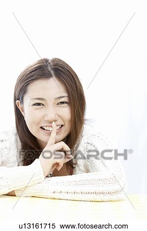 Young woman with finger on lips, Tokyo Prefecture, Honshu, Japan View Large Photo Image Stock Photography - Young woman with finger on lips, Tokyo Prefecture, Honshu, Japan. Fotosearch