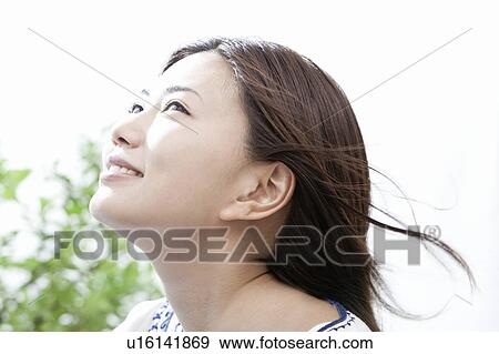 Young woman with hair blowing in the wind, Tokyo Prefecture, Honshu, Japan View Large Photo Image Stock Photo - Young woman with hair blowing in the wind, Tokyo Prefecture, Honshu, Japan. Fotosearch