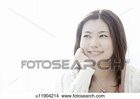 Young woman with hand on chin, Tokyo Prefecture, Honshu, Japan View Large Photo Image Picture - Young woman with hand on chin, Tokyo Prefecture, Honshu, Japan. Fotosearch