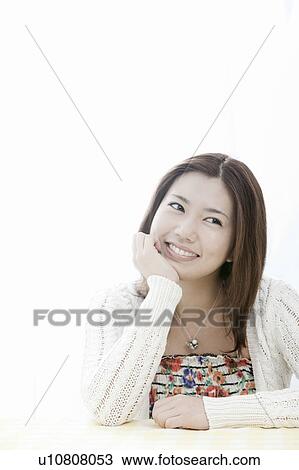 Young woman with hand on chin, Tokyo Prefecture, Honshu, Japan View Large Photo Image Stock Image - Young woman with hand on chin, Tokyo Prefecture, Honshu, Japan. Fotosearch