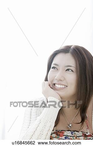 Young woman with hand on chin, Tokyo Prefecture, Honshu, Japan View Large Photo Image Stock Image - Young woman with hand on chin, Tokyo Prefecture, Honshu, Japan. Fotosearch