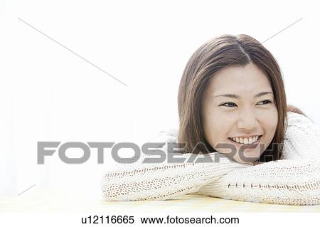 Stock Photography - Young woman with head in hands, Tokyo Prefecture, Honshu, Japan. Fotosearch