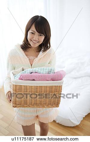 Stock Photo - Young Woman with Laundry Basket. Fotosearch