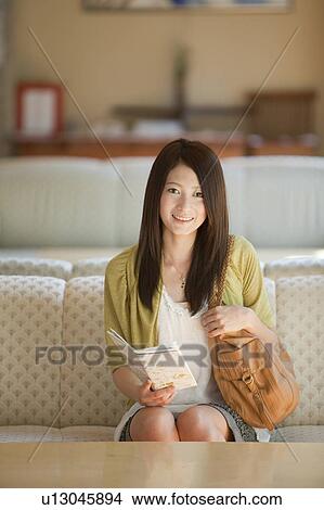 Young Woman with Map Sitting in Lobby View Large Photo Image Picture - Young Woman with Map Sitting in Lobby. Fotosearch