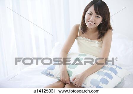 Stock Image - Young Woman with Pillow. Fotosearch