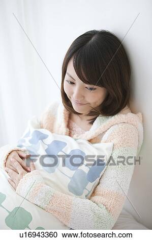Stock Image - Young Woman with Pillow. Fotosearch
