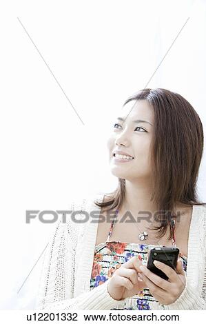 Young woman with smart phone, Tokyo Prefecture, Honshu, Japan View Large Photo Image Stock Image - Young woman with smart phone, Tokyo Prefecture, Honshu, Japan. Fotosearch