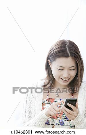 Young woman with smart phone, Tokyo Prefecture, Honshu, Japan View Large Photo Image Stock Image - Young woman with smart phone, Tokyo Prefecture, Honshu, Japan. Fotosearch