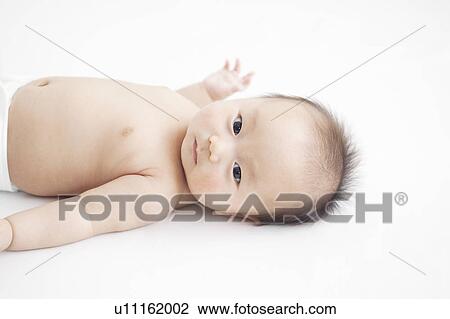 Stock Image - Baby lying on back. Fotosearch