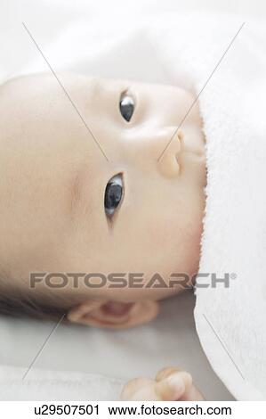 Stock Image - Baby lying on back. Fotosearch