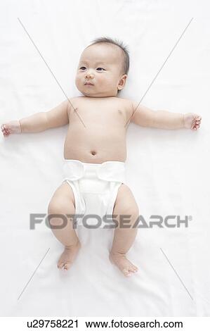 Stock Image - Baby lying on back. Fotosearch