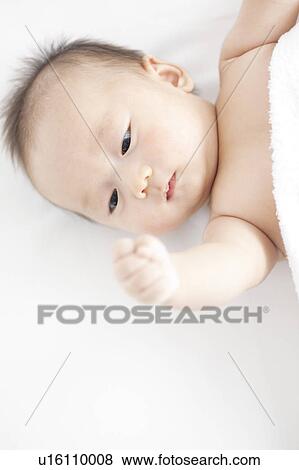 Baby lying on back View Large Photo Image Stock Photo - Baby lying on back. Fotosearch