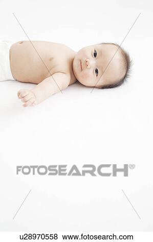 Stock Photo - Baby lying on back. Fotosearch