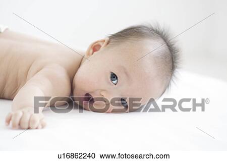 Stock Image - Baby lying on front. Fotosearch