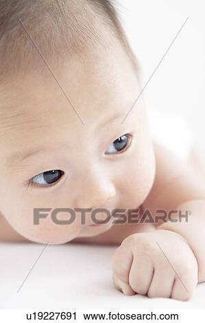 Baby lying on front View Large Photo Image Stock Image - Baby lying on front. Fotosearch