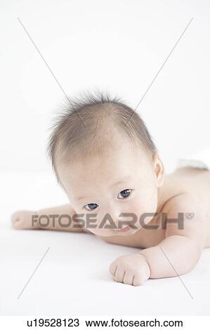 Stock Image - Baby lying on front. Fotosearch