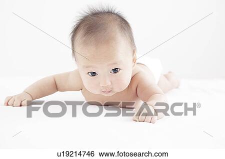 Stock Photograph - Baby lying on front. Fotosearch