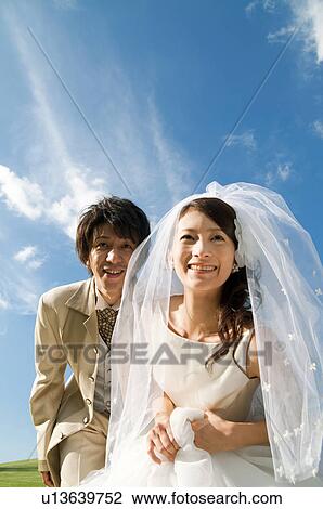 Stock Image - Bride and bridegroom getting ready to run. Fotosearch