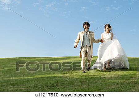 Bride and bridegroom holding hands View Large Photo Image Stock Image - Bride and bridegroom holding hands. Fotosearch
