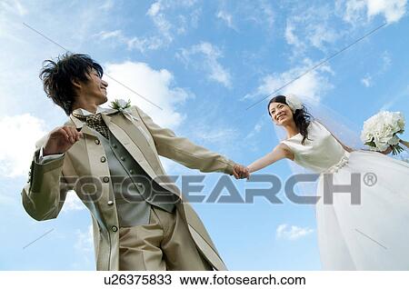 Bride and bridegroom holding hands View Large Photo Image Stock Image - Bride and bridegroom holding hands. Fotosearch