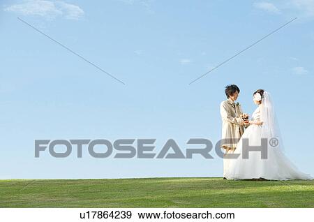 Bride and bridegroom holding hands View Large Photo Image Stock Photo - Bride and bridegroom holding hands. Fotosearch