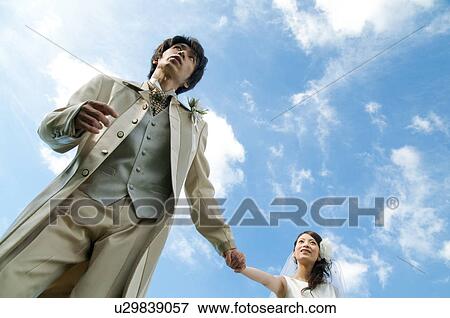 Bride and bridegroom holding hands View Large Photo Image Stock Photo - Bride and bridegroom holding hands. Fotosearch