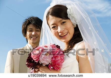 Picture - Bride and bridegroom looking at camera. Fotosearch
