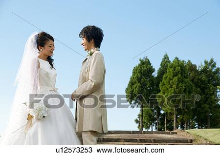Bride and bridegroom standing face to face View Large Photo Image Stock Image - Bride and bridegroom standing face to face. Fotosearch