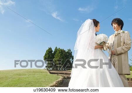 Bride and bridegroom standing face to face View Large Photo Image Stock Photo - Bride and bridegroom standing face to face. Fotosearch