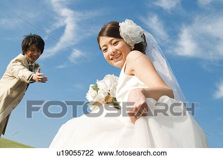 Bride looking at camera and bridegroom reaching out View Large Photo Image Stock Image - Bride looking at camera and bridegroom reaching out. Fotosearch