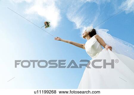 Bride throwing a bouquet View Large Photo Image Stock Photo - Bride throwing a bouquet. Fotosearch