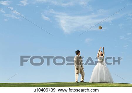 Bride throwing bouquet into the air View Large Photo Image Stock Photo - Bride throwing bouquet into the air. Fotosearch
