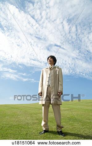 Picture - Bridegroom standing outdoors. Fotosearch