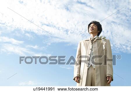 Stock Image - Bridegroom standing outdoors. Fotosearch