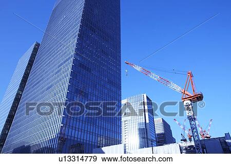 Stock Photo - Building under construction and crane, Chiyoda Ward, Tokyo Prefecture, Honshu, Japan. Fotosearch