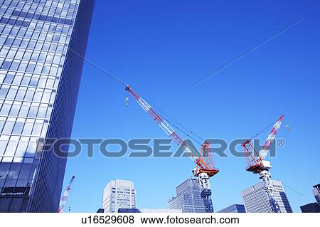 Stock Photo - Building under construction and crane, Chiyoda Ward, Tokyo Prefecture, Honshu, Japan. Fotosearch