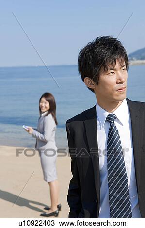 Stock Image - Business people at beach . Fotosearch