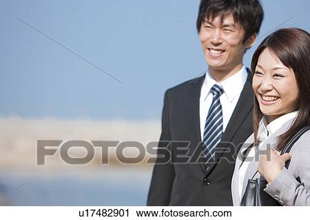Stock Image - Business people at beach . Fotosearch