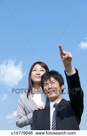Business people looking away and pointing View Large Photo Image Stock Photograph - Business people looking away and pointing. Fotosearch