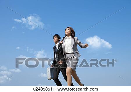 Stock Image - Business people running. Fotosearch