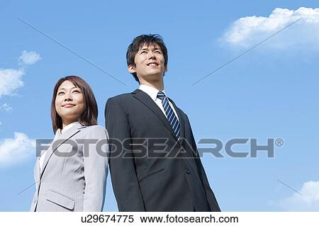 Business people standing, low angle view View Large Photo Image Stock Photography - Business people standing, low angle view. Fotosearch