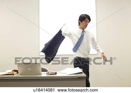 Businessman grabbing his jacket and leaving desk View Large Photo Image Stock Image - Businessman grabbing his jacket and leaving desk. Fotosearch
