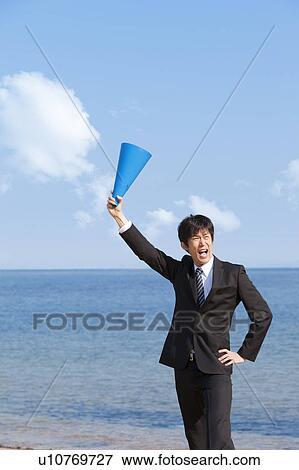 Businessman holding a megaphone View Large Photo Image Stock Photo - Businessman holding a megaphone. Fotosearch