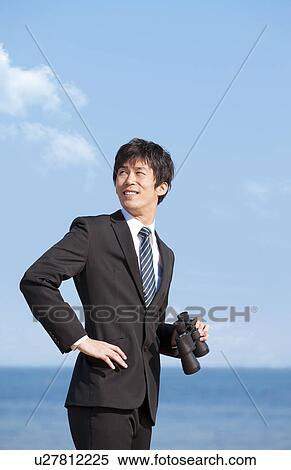 Businessman holding binoculars View Large Photo Image Stock Photography - Businessman holding binoculars. Fotosearch