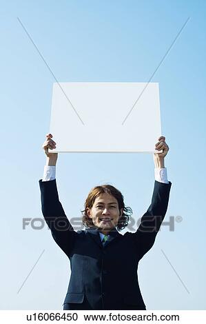 Stock Image - Businessman Holding Message Board Aloft. Fotosearch