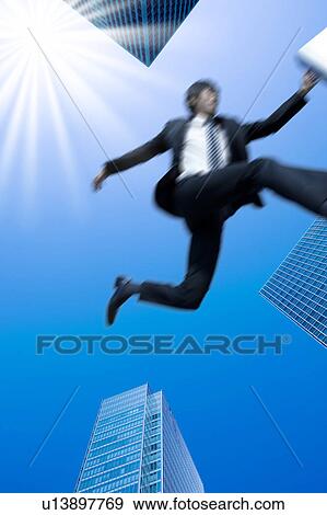 Businessman jumping in the air View Large Photo Image Stock Photo - Businessman jumping in the air. Fotosearch
