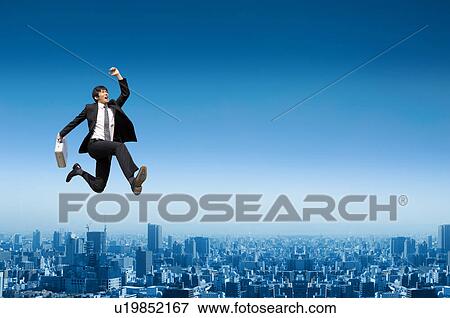 Businessman jumping in the air View Large Photo Image Stock Photo - Businessman jumping in the air. Fotosearch